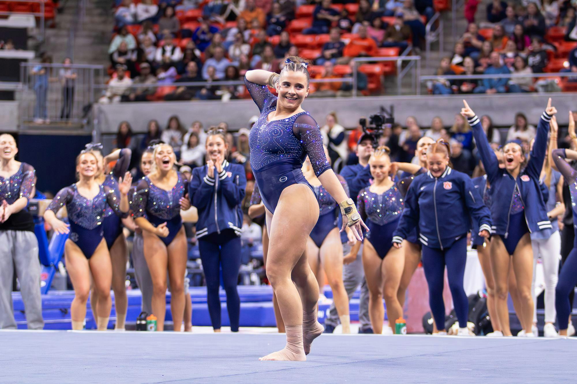 Julianne Huff finishes her floor routine with her teammates cheering her on during the meet against Florida on Jan. 23, 2026 in Neville Arena in Auburn, Ala. 