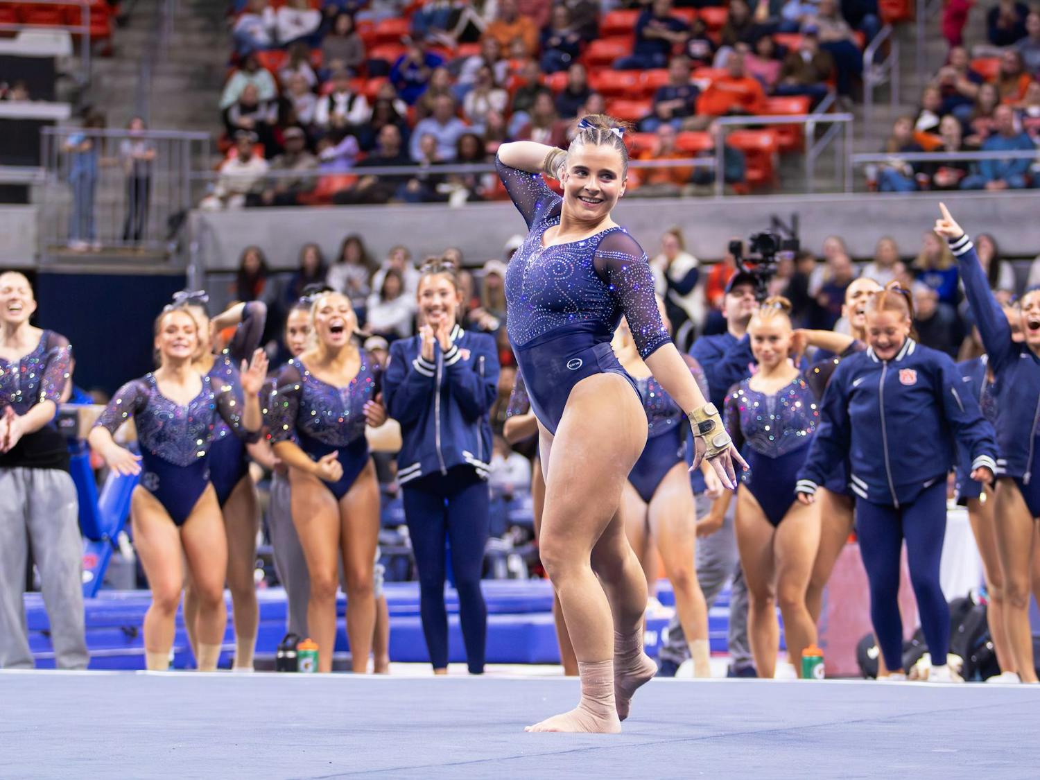 Julianne Huff finishes her floor routine with her teammates cheering her on during the meet against Florida on Jan. 23, 2026 in Neville Arena in Auburn, Ala.