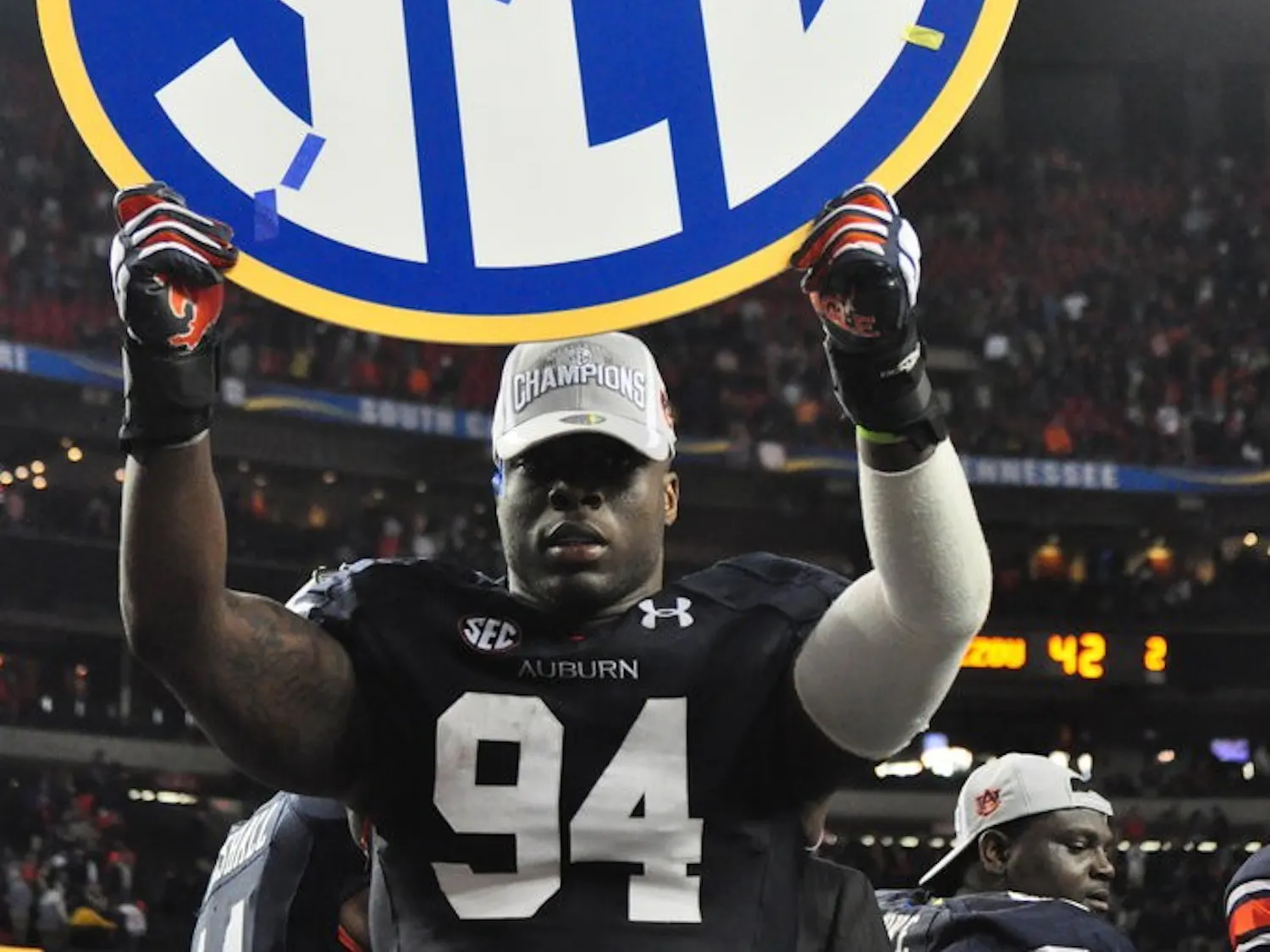 Nosa Eguae holds up the SEC logo to celebrate the Auburn win against Missouri Saturday. Anna Grafton / PHOTO EDITOR
