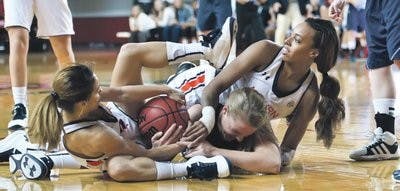 Auburn's Najat Ouardad (3) and Tyrese Tanner (32) battle for a loose ball with a Maine player. The Tigers defeated Maine 71-41 in the 2012-13 season-opener. (Courtesy of Greg Mintel)