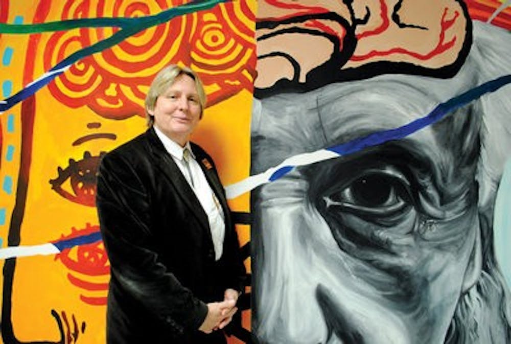 Anna Gramberg, CLA dean, stands by a mural of famous German scientist Albert Einstein. (Maria Iampietro / Associate Photo Editor )