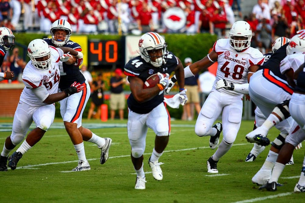 Cameron Artis-Payne (#44) runs with ball. Auburn vs. Arkansas, August 30, 2014. (Kenny Moss | Photographer)