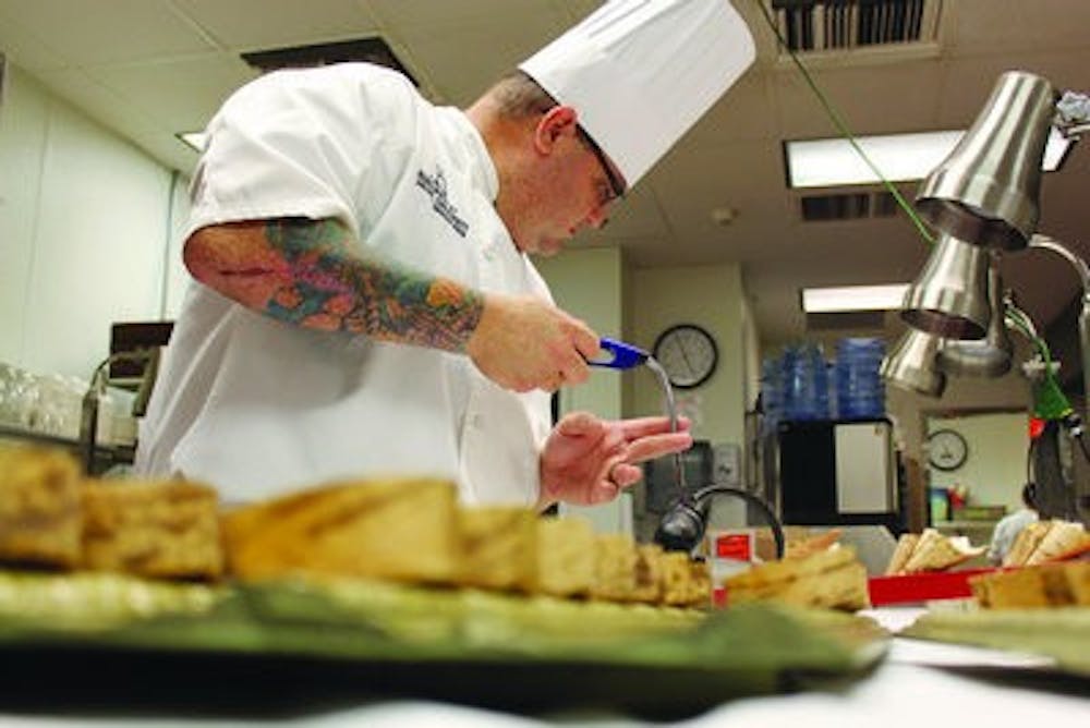 Chef Leonardo Maurelli prepares appetizers for guest. (Alex Sager / PHOTO EDITOR)