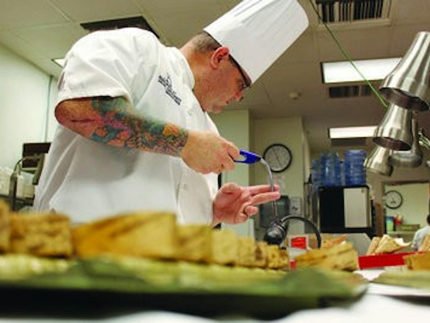 Chef Leonardo Maurelli prepares appetizers for guest. (Alex Sager / PHOTO EDITOR)