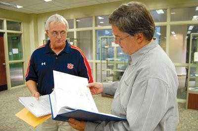 Bob Harwell points out one of the missions his father wrote about in his book "Combat Missions" to Greg Schmidt June 21. (Kristen Ferrell / CAMPUS EDITOR)