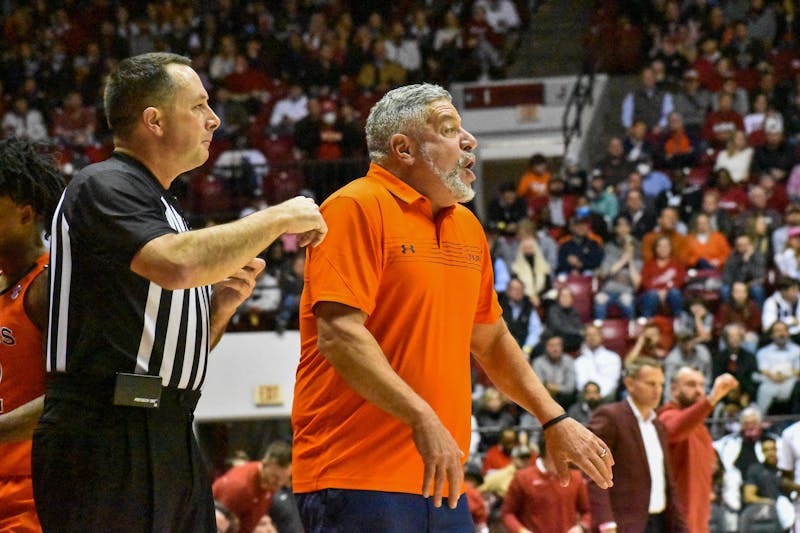 January 11, 2022; Tuscaloosa, Alabama; Auburn head coach Bruce Pearl communicates with players from the sideline while Alabama head coach Nate Oats sits in the background.