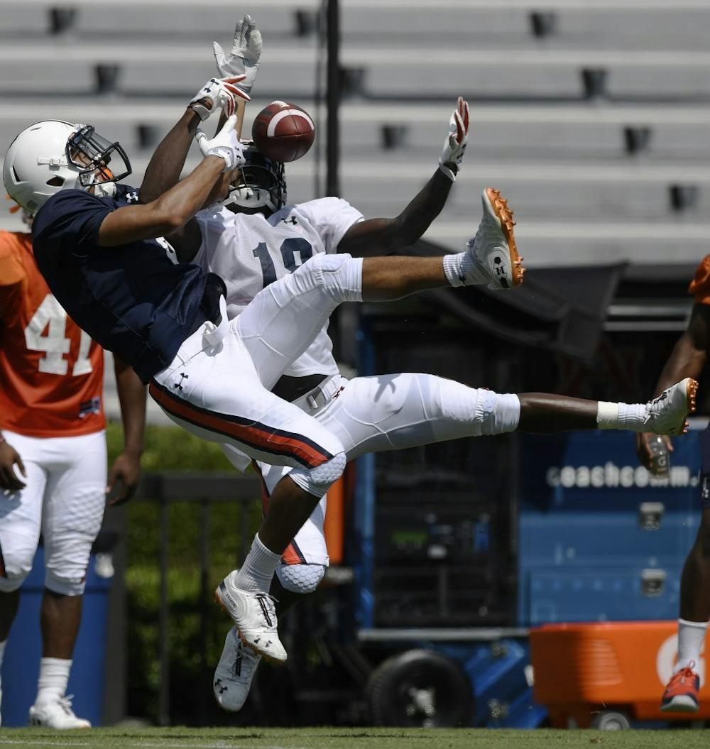 Defender Jayvaughn Myers takes the ball and makes the interception from receiver Anthony Schwartz during scrimmage Thursday.Auburn football scrimmage on Thursday, Aug. 9, 2018 in Auburn, Ala.Todd Van Emst/AU Athletics 