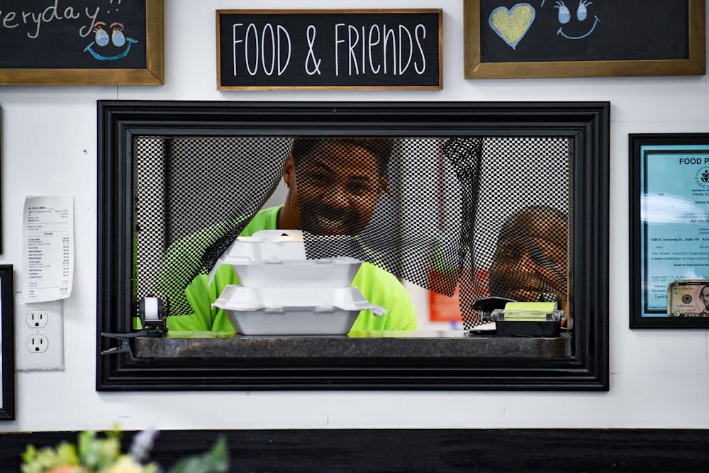 <p>Sharon and Dewrell Dowdell share a smile in front of the fresh food that they just cooked inside of Opelika's All I Do is BBQ's kitchen on May 26, 2022.</p>