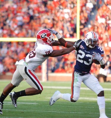 Sophomore running back Onterio McCalebb stiff-arms Bacarri Rambo. (Charlie Timberlake/Assistant Photo Editor)