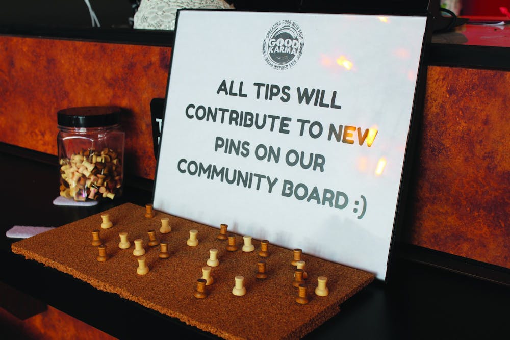 The owner of Good Karma puts a community board inside the restaurant to help those in need. 