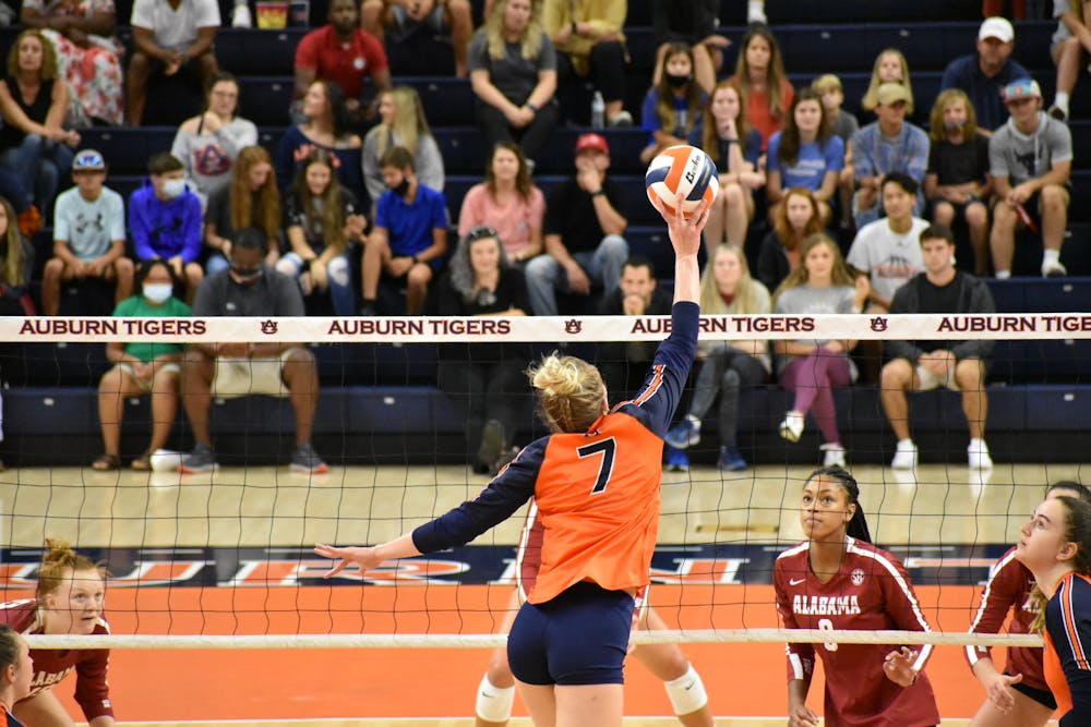 <p>Oct. 3, 2021; Auburn, AL, USA; Rebekah Rath (7) gently lifts the ball over the net in a match between Auburn and Alabama in the Auburn Arena.</p>