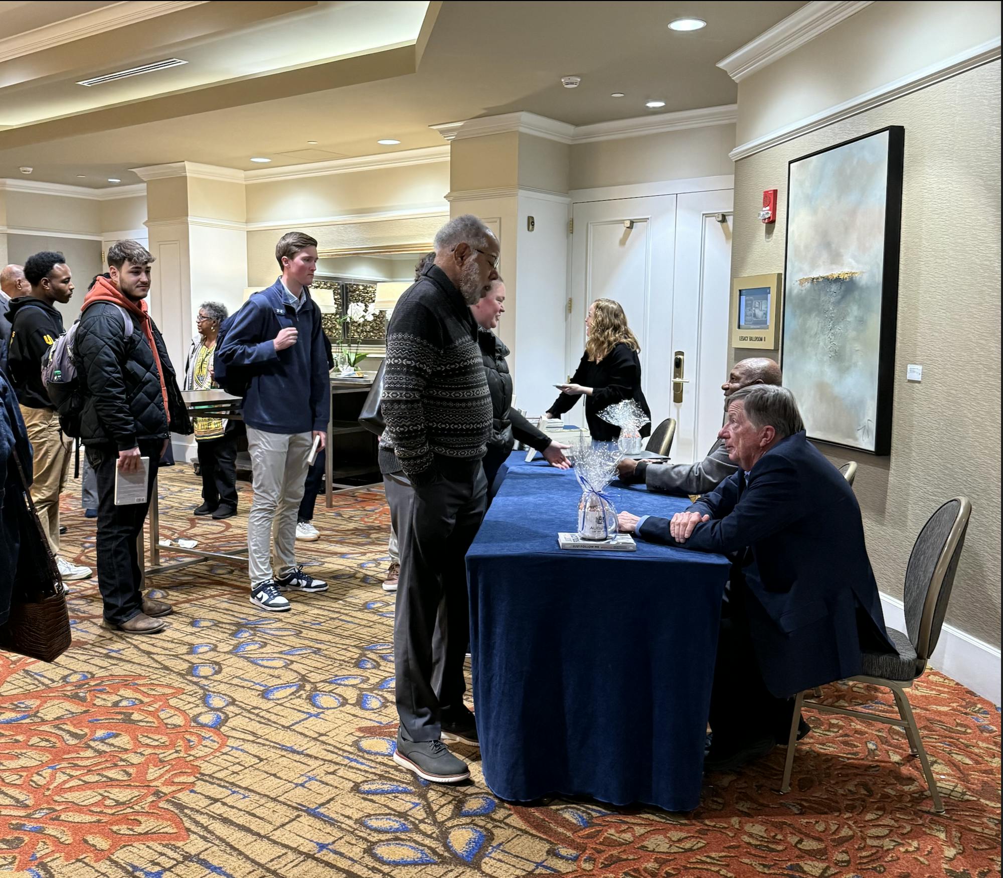 Thom Gossom Jr. and Sam Heys sign books and converse with attendants after book talk at The Hotel at Auburn University on Friday, Feb. 6, 2026.