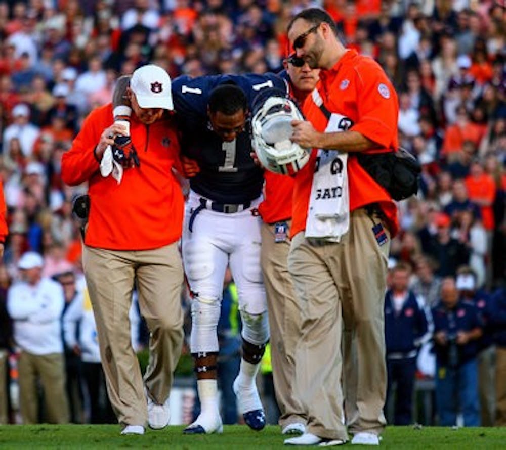 Duke Williams being escorted off the field with assistance from the medical staff. He did not return to today's game against Texas A&M. (Kenny Moss | Photographer)