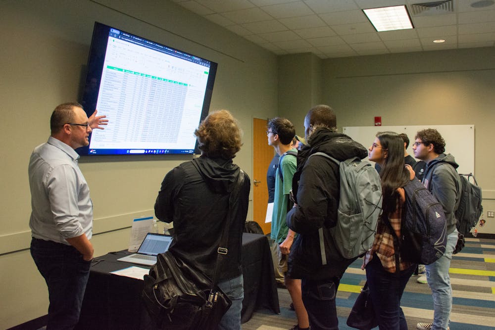 Students listening to a presentation on AI at the On the Pl(AI)ns Event in the Melton Student Center on January 25.