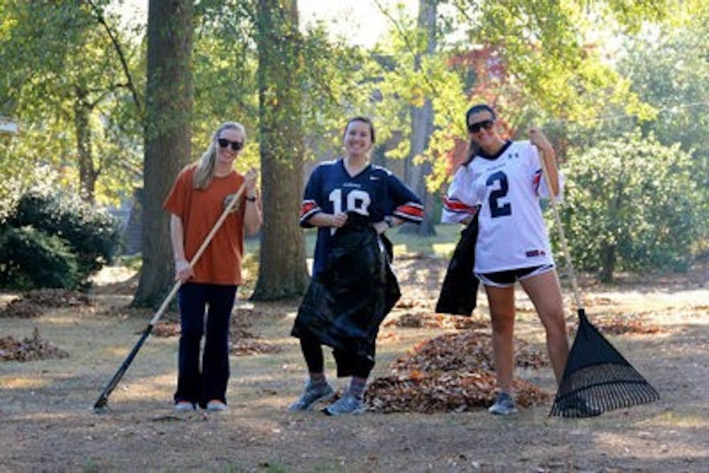 Olivia Yocum, sophomore in nutrition and dietetics, Julianna Cvetetic, sophomore in graphic design and Lexie Powers, sophomore in undeclared science and math, rake Auburn and Opelika natives' yards to raise money for the Make-A-Wish Foundation last fall. They raised close to $2,000 at this event that lasted a few weekends long. (Contributed by Olivia Yocum)