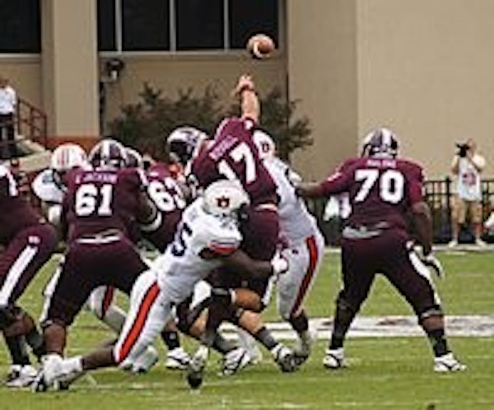 Corey Lemonier hurries Mississippi State quarterback Tyler Russell
