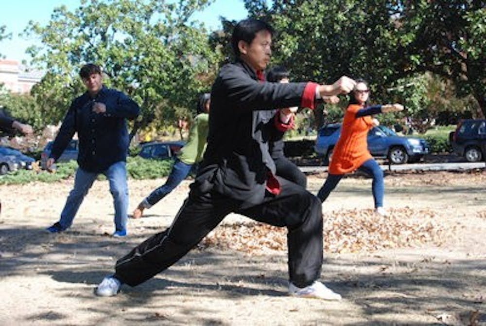 Qin Cai, Tai Chi coach, leading the International Tai Chi class outside Foy Hall.