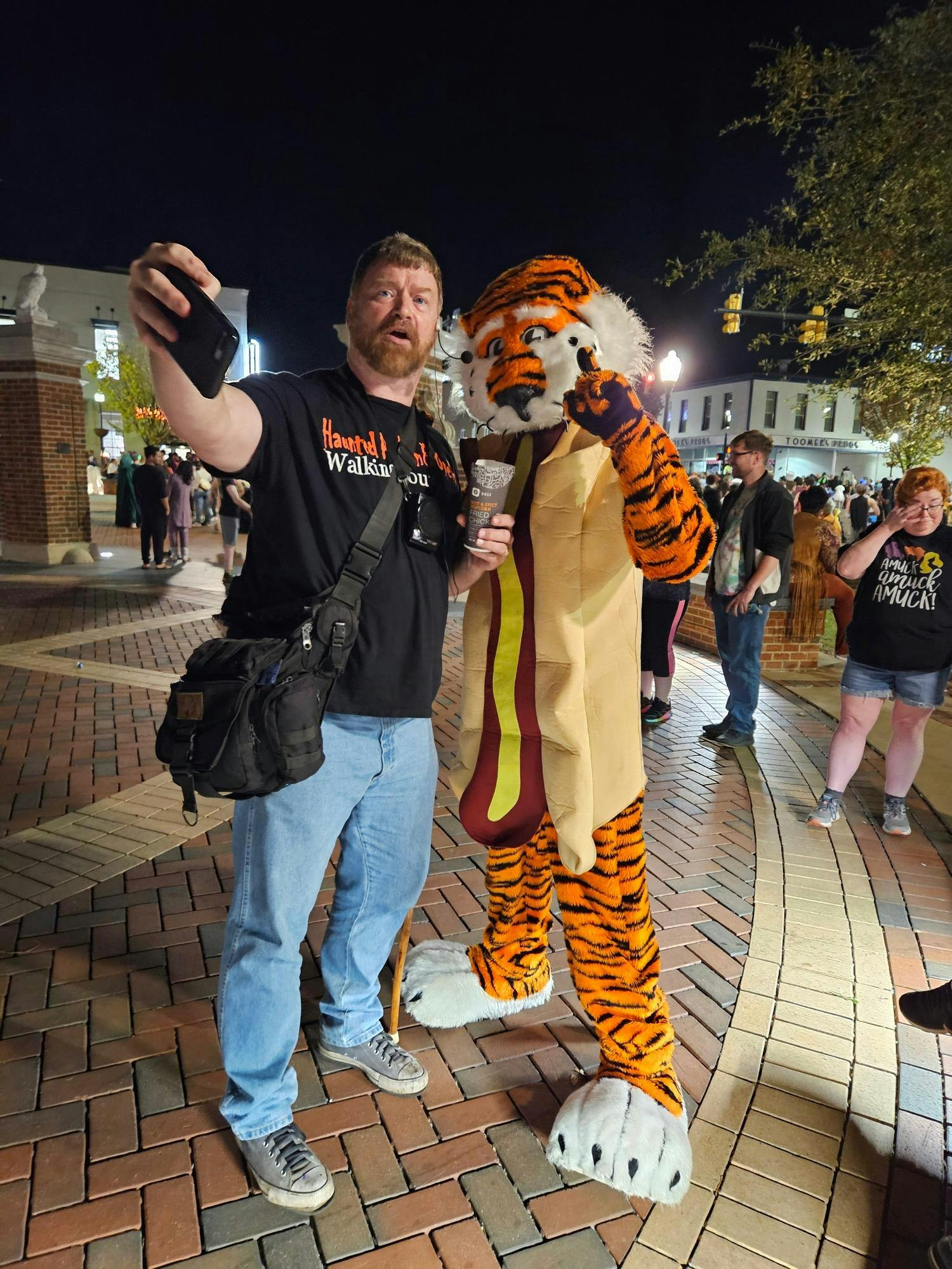 Brandon Stoker posing with Aubie at the starting point of the Auburn Walking Tours.