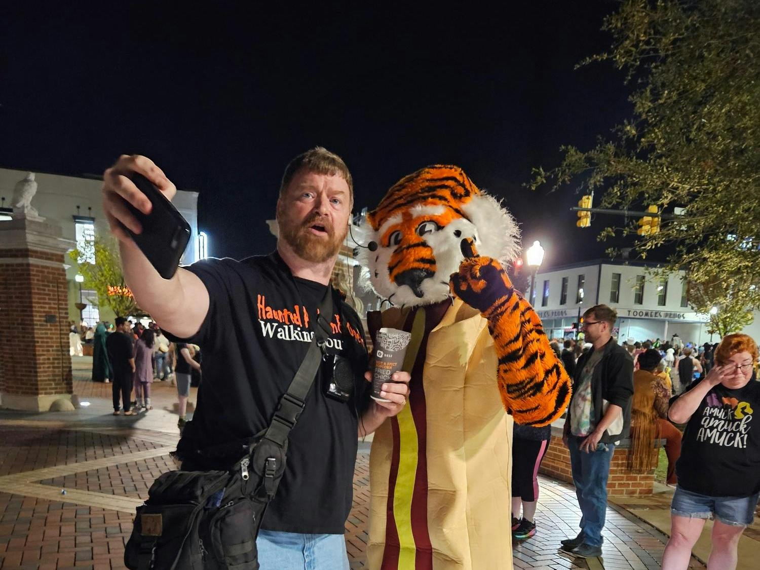 Brandon Stoker posing with Aubie at the starting point of the Auburn Walking Tours.