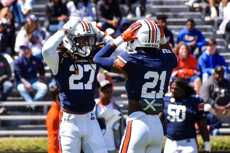Caleb Wooden (21) and Marquise Gilbert (27) hold their hands on their heads in disbelief after missing an interception during the 2022 A-Day game in Jordan-Hare Stadium in Auburn, Alabama, on April 9, 2022.
