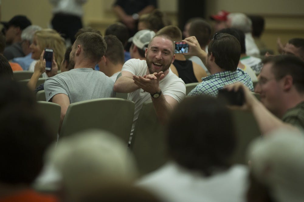 An alt-right supporter of Richard Spencer mocks a heckler during Spencer's talk on Tuesday, April 18, 2017 in Auburn, Ala. 