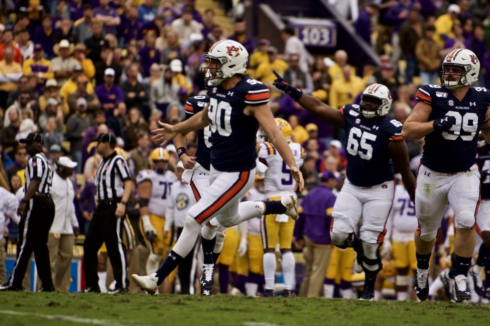 <p>Arryn Siposs (90) celebrates one of his punts during the Auburn vs. LSU game Saturday Oct. 26, 2019, in Baton Rogue, La.</p>