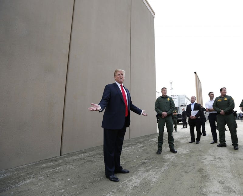 President Donald Trump tours the border wall prototypes near the Otay Mesa Port of Entry in San Diego County, Calif., on March 13, 2018. (K.C. Alfred/San Diego Union-Tribune/TNS)