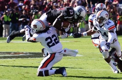 Junior defensive back T'Sharvan Bell tackles South Carolina wide reciever Bruce Ellington. (Robert E. Lee / ASSISTANT CAMPUS EDITOR)
