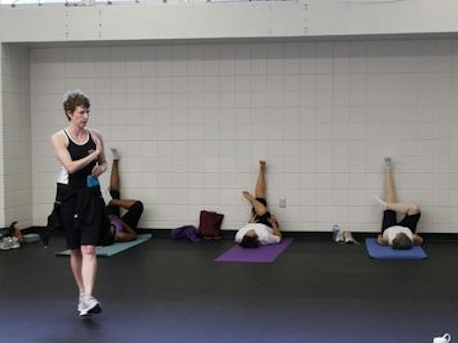 Lisa Padgett teaches one of her more challenging exercise classes, Wall Yoga, in the Student Activities Center.