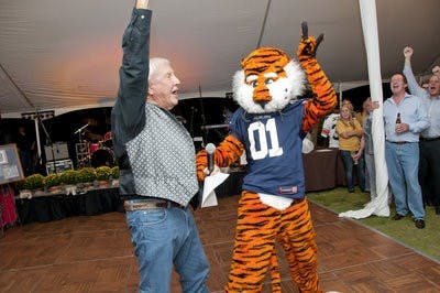 Pat Dye and Aubie celebrate on the dance floor after the 2013 Blue Jean Ball.