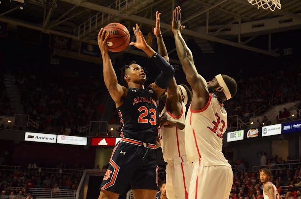 <p>Isaac Okoro (23) shoots over South Alabama defenders during Auburn basketball at South Alabama on Nov. 12, 2019, in Mobile, Ala.</p>
