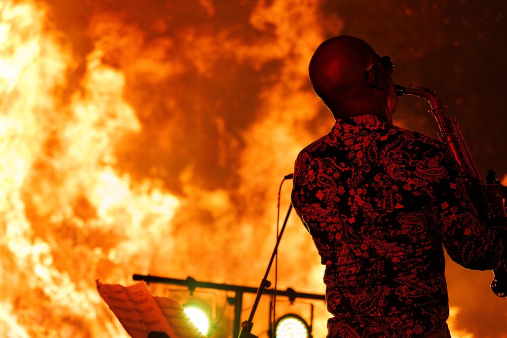 <p>Saxophonist Khari&nbsp;Allen Lee performs against a blazing bonfire at AubFest V on Saturday, Nov. 2, 2024. </p>
