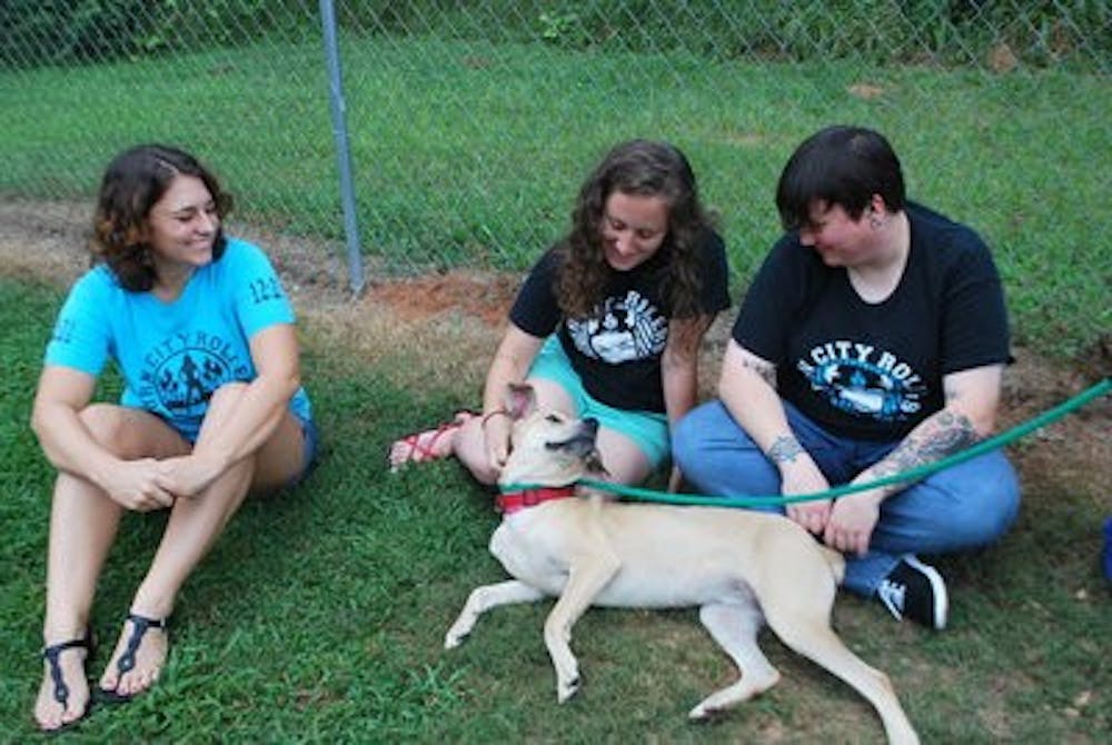 Ashley Pott, Andre Nelson and Jennifer Lisenby hang out with Humane Society canine buddy Venus.