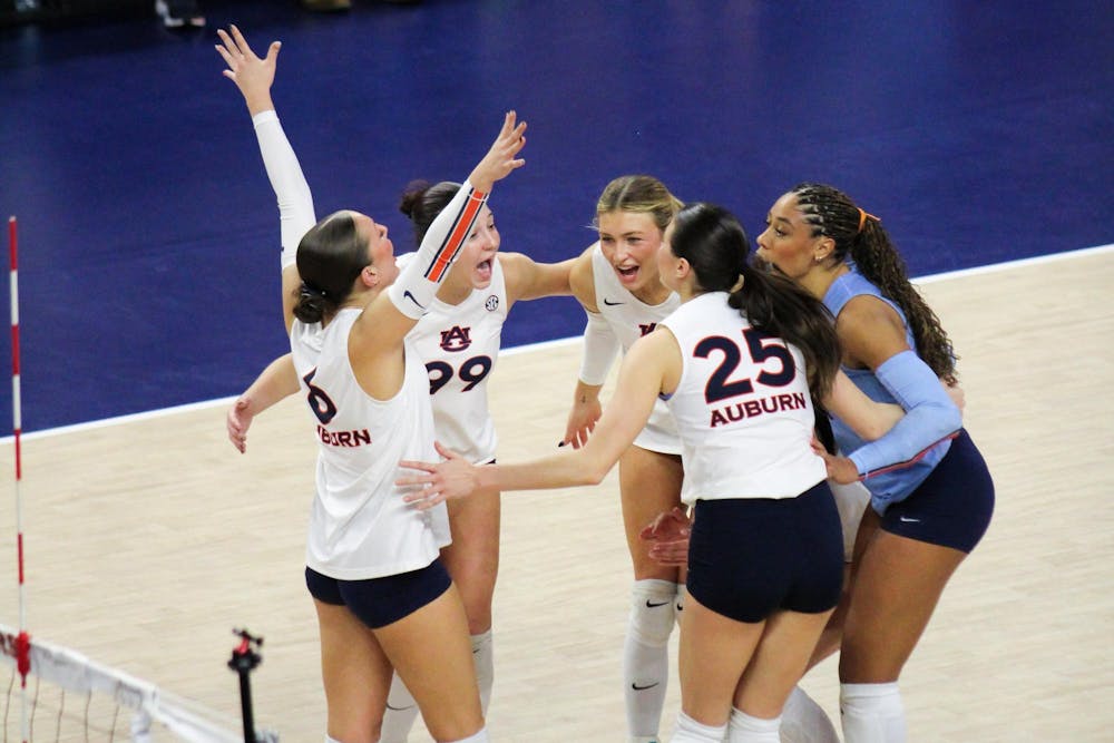 <p>The Auburn Volleyball team celebrates in a huddle after a point winning play against Texas A&amp;M at Neville Arena in Auburn, Ala. on Nov. 7, 2025.</p>