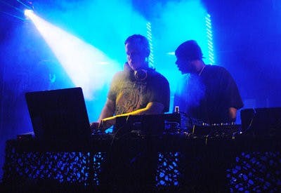 DJ Crude Carter (left) uses different lighting techniques to enhance the audience's dubstep experience at Bourbon Street Bar Saturday night. (Maria Iampietro / PHOTO EDITOR)