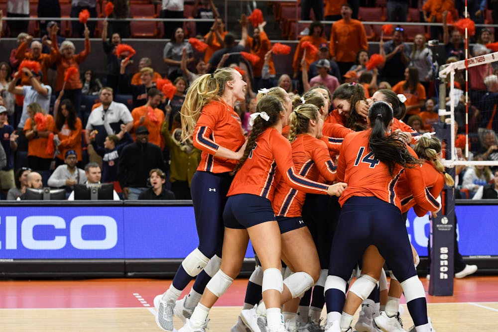 <p>Auburn volleyball team celebrates their set win against Georgia at the Neville Arena on Oct. 9, 2022.</p>