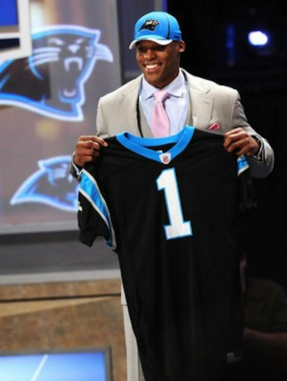 Auburn's Cam Newton poses with a Carolina Pathers jersey after being the number one selection in the 2011 NFL Draft. (Todd Van Emst / Auburn Media Relations)