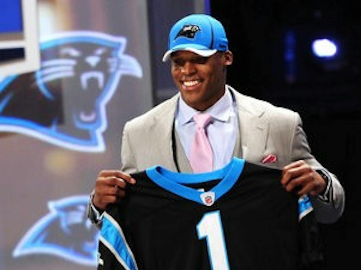 Auburn's Cam Newton poses with a Carolina Pathers jersey after being the number one selection in the 2011 NFL Draft. (Todd Van Emst / Auburn Media Relations)