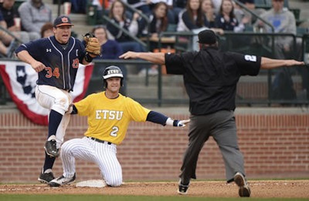 Auburn's Blake Austin reacts to ETSU's Chris Cook being called safe at third base in the top of the 10th inning. Cook would go on to score the winning run. (Contributed by Zach Bland)