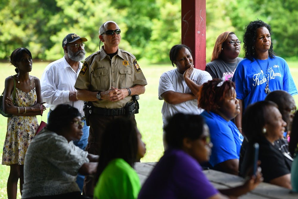 Auburn residents gather with Lee county sheriff Jay Jones&nbsp;during a separate&nbsp;Stop the Violence rally at Sam Harris Park on Sat. April 30, 2016 in Auburn, Ala. Opelika community members gathered earlier in June.