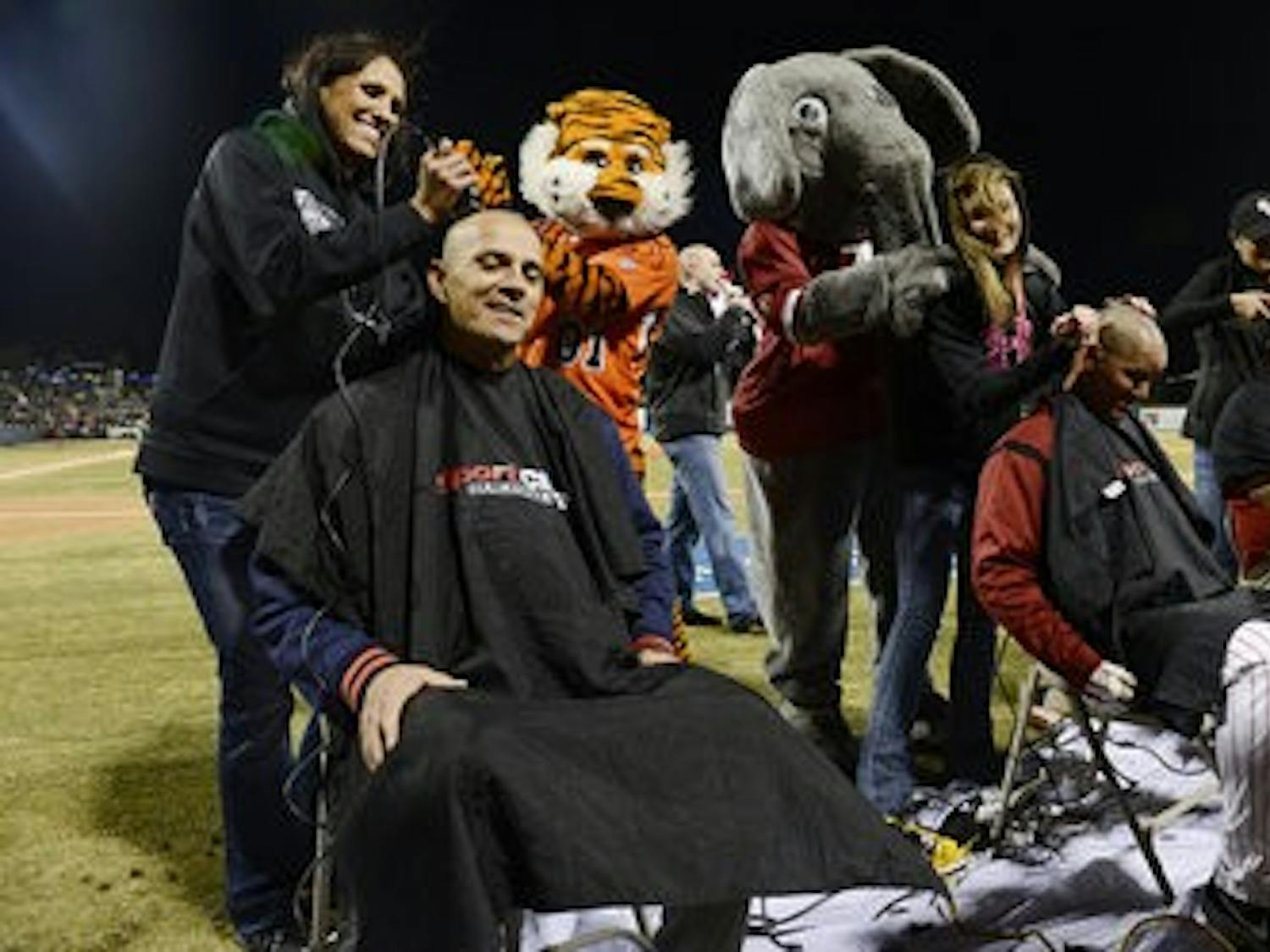 Auburn coach John Pawlowski and Alabama coach Mitch Gaspard have their heads shaved Tuesday March 5, before the game begins. (Courtesy of Todd Van Emst / AUBURN ATHLETICS)