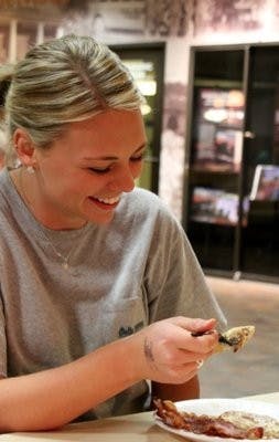 Sarah Mitchell, freshman in health service administration, enjoys the
delicious pancakes at Flap Jack Fest held Thursday, March 7. (Katherine McCahey / Assistant Photo Editor)