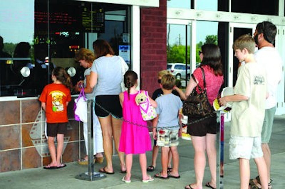 Customers file in line at the box office of Carmike theater to purchase tickets for an afternoon movie.( Christen Harned / ASSISTANT PHOTO EDITOR)