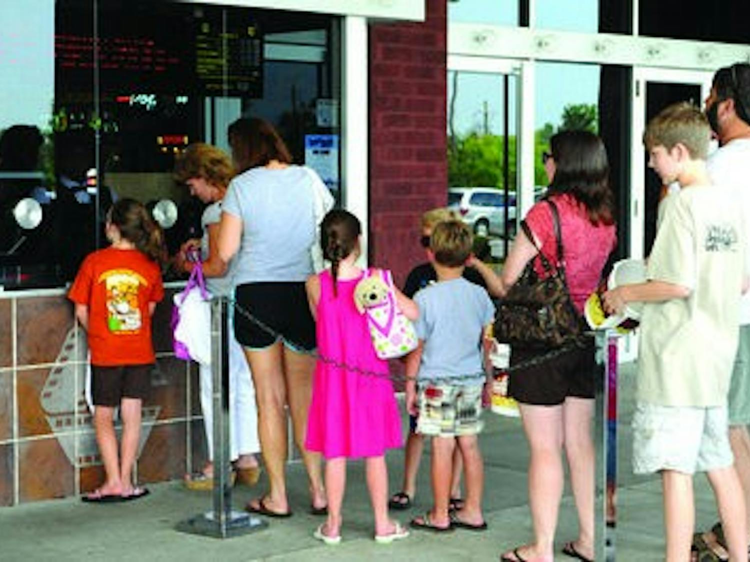 Customers file in line at the box office of Carmike theater to purchase tickets for an afternoon movie.( Christen Harned / ASSISTANT PHOTO EDITOR)