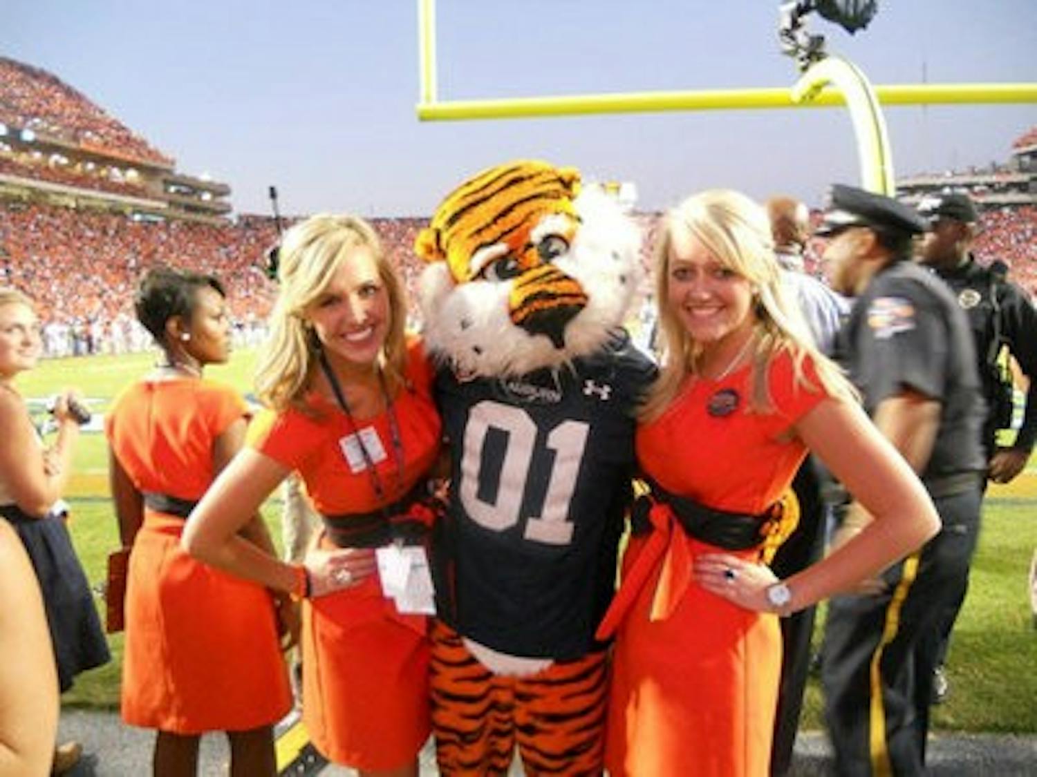 Jamie Nolen and Lauren Taylor smile with Aubie during a home game this season. (Contributed)