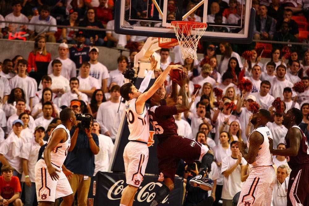 Alex Thompson, 20, blocks the shot of a Mississippi State player. (Kenny Moss | Photographer)