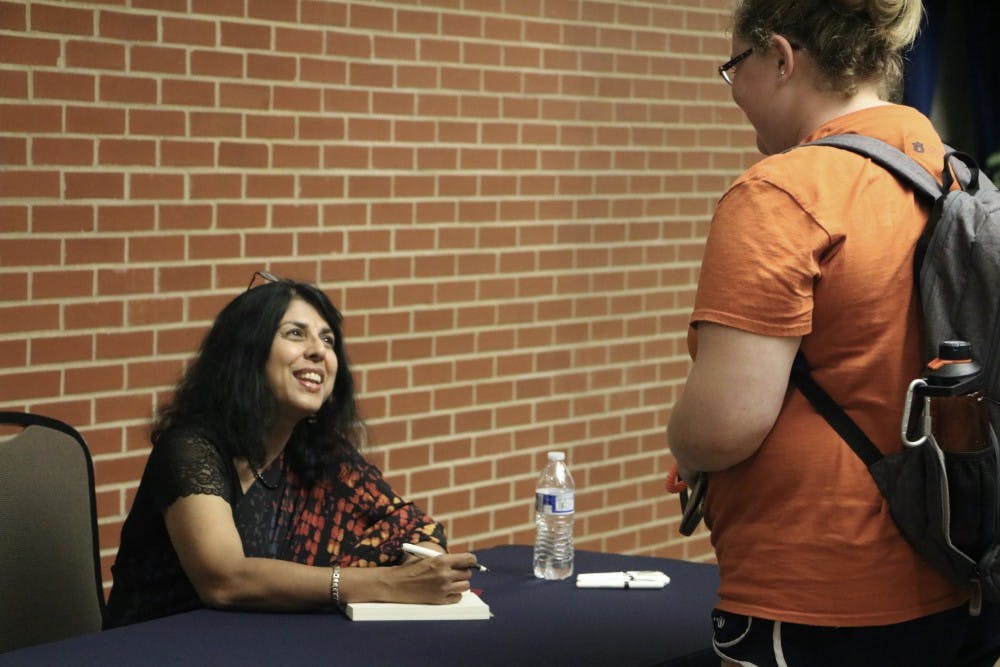 Chitra Divakaruni, author of "One Amazing Thing," signs one of her books during the Auburn Keynote and Book Signing Wednesday Sept. 19 in Auburn, Ala.