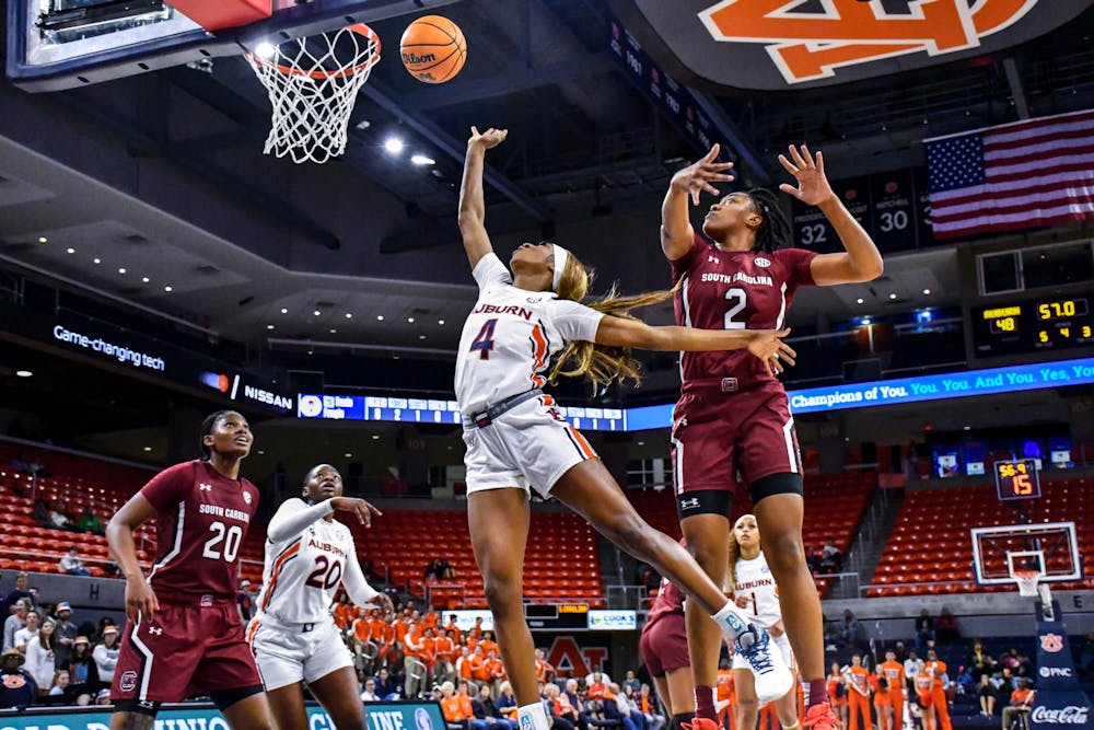 <p>Auburn's Women's Basketball player Kaitlyn Duhon (4) fights to score 2 point shot against the South Carolina Gamecocks in Neville Arena on Feb. 9, 2023.</p>