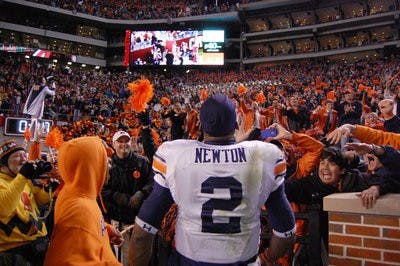 Junior quarterback Cam Newton celebrates with the Auburn student section after Auburn's Iron Bowl win. (Charlie Timberlake/ASSISTANT PHOTO EDITOR)