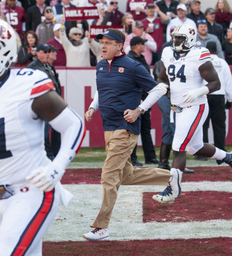 Head coach Gus Malzahn trots onto the field with his team pregame. Auburn vs Alabama on Saturday, Nov. 26 in Tuscaloosa, AL.